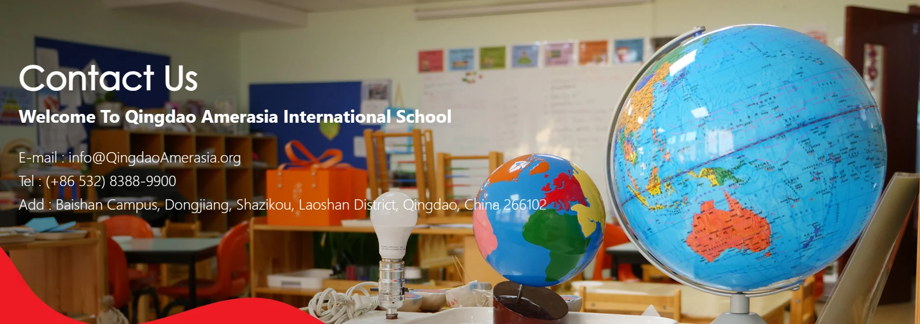Classroom scene at Qingdao International School featuring colorful globes and educational tools, highlighting global education and contact info at QAIS.